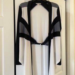 Unique top that can be worn flowy or tied at waist with cropped back